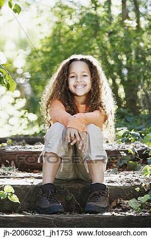 Young African girl smiling in woods View Large Photo Image Stock Image - Young African girl smiling in woods. Fotosearch