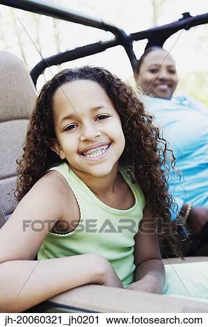 Young African girl with braces smiling and sitting in jeep View Large Photo Image Stock Image - Young African girl with braces smiling and sitting in jeep. Fotosearch