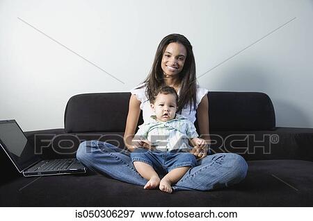 Young African mother with baby on lap View Large Photo Image Stock Photo - Young African mother with baby on lap. Fotosearch