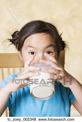 Stock Photo - Young Asian girl drinking milk. Fotosearch