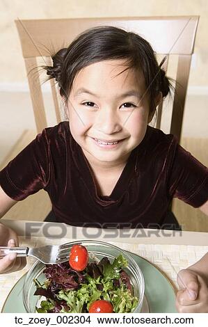 Young Asian girl eating salad View Large Photo Image Picture - Young Asian girl eating salad. Fotosearch