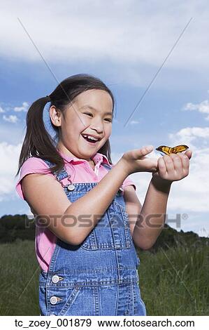 Young Asian girl holding butterfly outdoors View Large Photo Image Stock Photo - Young Asian girl holding butterfly outdoors. Fotosearch