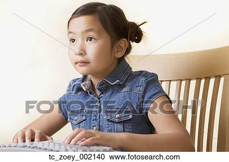 Young Asian girl using computer View Large Photo Image Stock Image - Young Asian girl using computer. Fotosearch