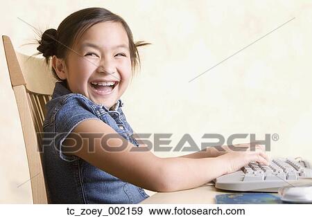 Young Asian girl using computer View Large Photo Image Stock Photo - Young Asian girl using computer. Fotosearch