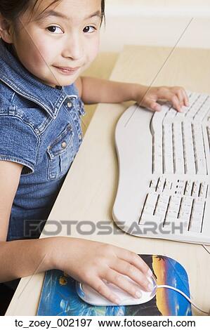 Young Asian girl using computer View Large Photo Image Stock Photo - Young Asian girl using computer. Fotosearch