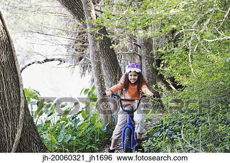 Young girl on bicycle in woods View Large Photo Image Stock Photograph - Young girl on bicycle in woods. Fotosearch
