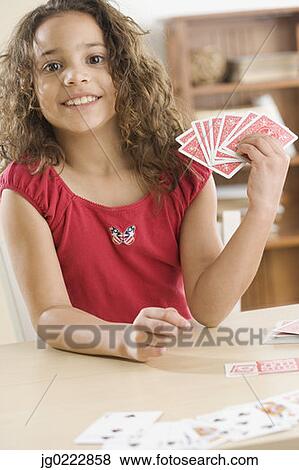 Stock Photo - Young girl playing cards. Fotosearch