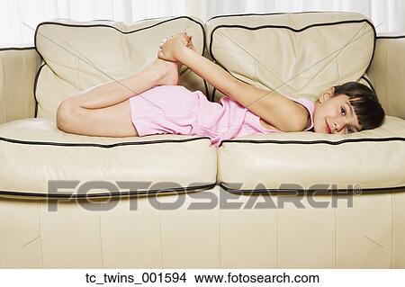 Young Hispanic girl laying on sofa View Large Photo Image Picture - Young Hispanic girl laying on sofa. Fotosearch