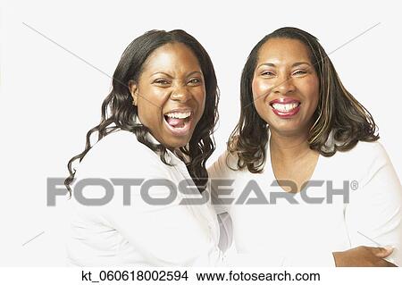 Picture - Adult African sisters laughing. Fotosearch