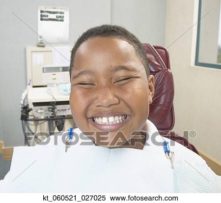 African boy smiling in dentist's chair View Large Photo Image Stock Photography - African boy smiling in dentist's chair. Fotosearch