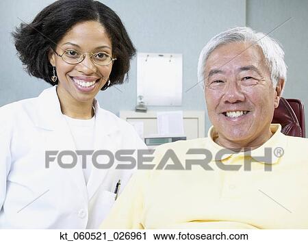 African female dentist with senior male patient View Large Photo Image Stock Image - African female dentist with senior male patient. Fotosearch