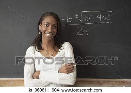African female student next to math problem on blackboard View Large Photo Image Picture - African female student next to math problem on blackboard. Fotosearch