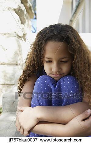 African girl leaning chin on knees outdoors View Large Photo Image Stock Photo - African girl leaning chin on knees outdoors. Fotosearch