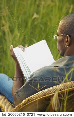 African man reading in field View Large Photo Image Stock Image - African man reading in field. Fotosearch