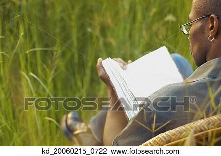 African man reading in field View Large Photo Image Stock Image - African man reading in field. Fotosearch