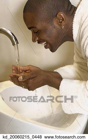 African man washing face in sink View Large Photo Image Stock Photo - African man washing face in sink. Fotosearch