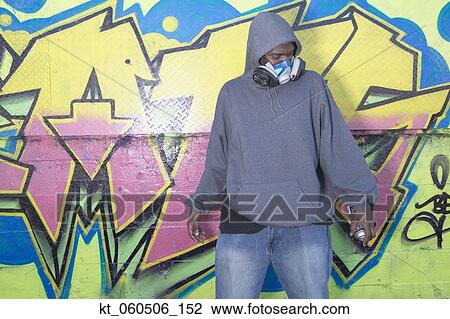 African man with spray paint next to graffitied wall View Large Photo Image Stock Image - African man with spray paint next to graffitied wall. Fotosearch