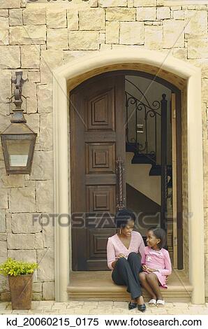 African mother and daughter sitting on doorstep View Large Photo Image Stock Photography - African mother and daughter sitting on doorstep. Fotosearch