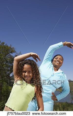 African mother and daughter stretching outdoors View Large Photo Image Stock Image - African mother and daughter stretching outdoors. Fotosearch