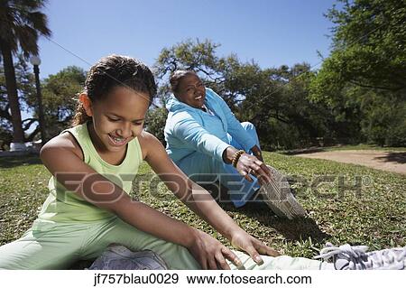 African mother and daughter stretching outdoors View Large Photo Image Stock Photo - African mother and daughter stretching outdoors. Fotosearch
