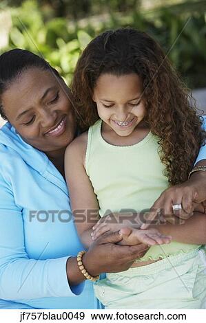 African mother and daughter with braces smiling View Large Photo Image Stock Photo - African mother and daughter with braces smiling. Fotosearch