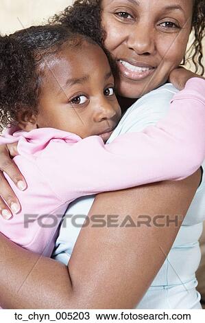 African mother and young daughter hugging View Large Photo Image Stock Image - African mother and young daughter hugging. Fotosearch