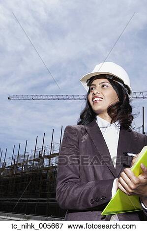 Stock Photo - Asian businesswoman wearing hard hat. Fotosearch