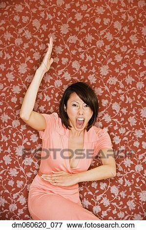 Stock Photo - Asian woman in dress doing martial arts move . Fotosearch