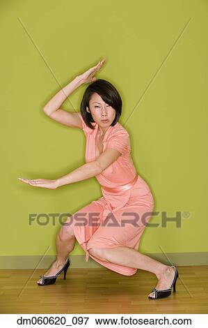 Asian woman in dress doing martial arts move View Large Photo Image Stock Photo - Asian woman in dress doing martial arts move . Fotosearch