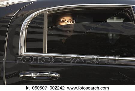 Asian woman in limousine with window part of the way down View Large Photo Image Stock Image - Asian woman in limousine with window part of the way down. Fotosearch