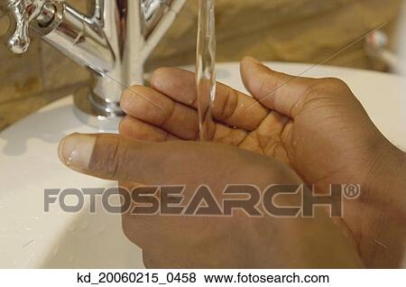 Close up of African man's hands under water in sink View Large Photo Image Stock Photo - Close up of African man's hands under water in sink. Fotosearch