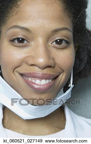 Close up of African woman smiling with surgical mask View Large Photo Image Stock Photo - Close up of African woman smiling with surgical mask. Fotosearch