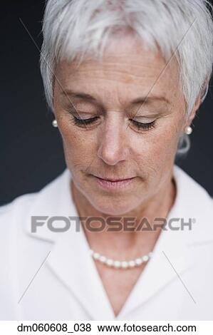 Stock Photo - Close up of senior woman looking down . Fotosearch