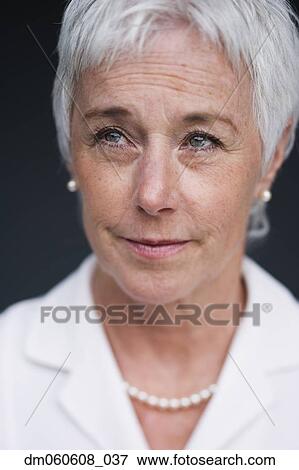 Stock Photo - Close up of senior woman looking up . Fotosearch
