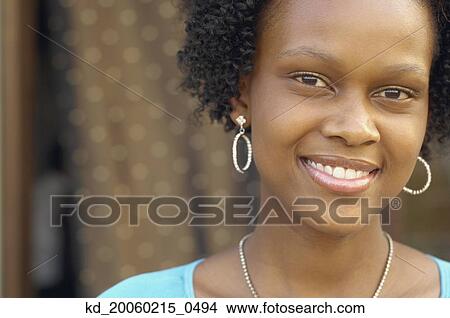 Picture - Close up of young African woman smiling. Fotosearch