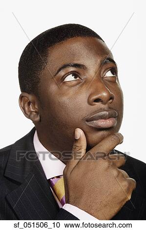 Close up studio shot of African man thinking View Large Photo Image Stock Image - Close up studio shot of African man thinking. Fotosearch