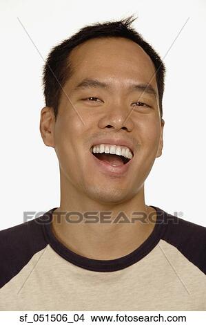 Picture - Close up studio shot of Asian man laughing. Fotosearch
