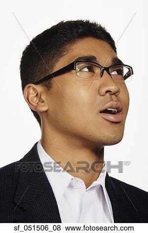 Close up studio shot of Asian man looking up View Large Photo Image Stock Photo - Close up studio shot of Asian man looking up. Fotosearch