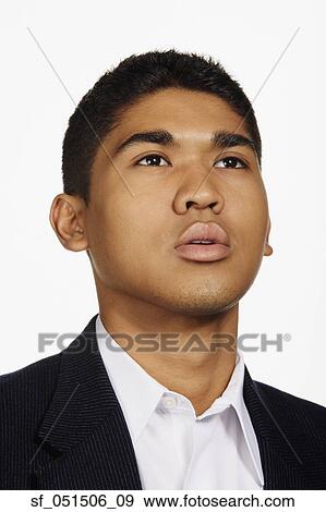 Close up studio shot of Asian man looking up View Large Photo Image Stock Photo - Close up studio shot of Asian man looking up. Fotosearch