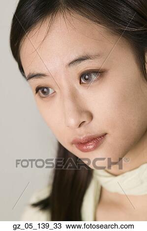 Stock Image - Close up studio shot of Asian woman . Fotosearch