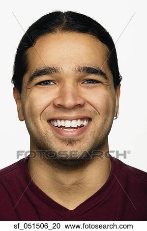 Stock Image - Close up studio shot of Hispanic man smiling. Fotosearch