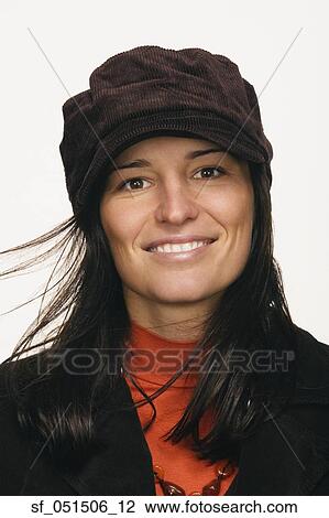 Close up studio shot of woman wearing hat and smiling View Large Photo Image Stock Image - Close up studio shot of woman wearing hat and smiling. Fotosearch