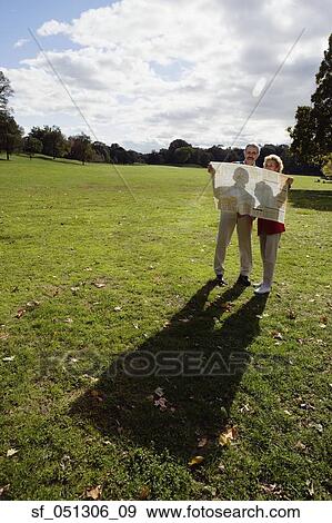 Stock Photo - Couple looking at map outdoors. Fotosearch