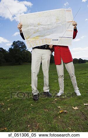 Stock Photography - Couple looking at map outdoors. Fotosearch