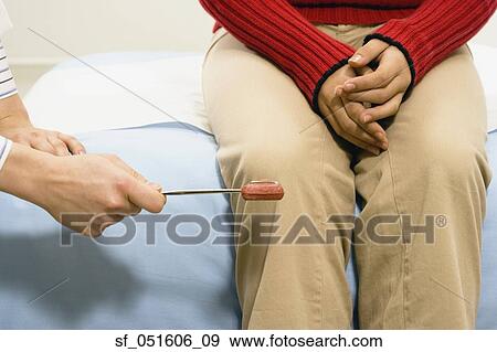 Doctor checking patient's reflexes View Large Photo Image Stock Photo - Doctor checking patient's reflexes. Fotosearch