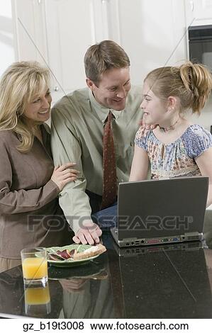 Family and laptop in kitchen View Large Photo Image Stock Photo - Family and laptop in kitchen . Fotosearch