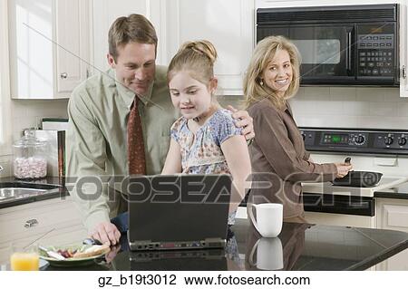 Family making breakfast and looking at laptop View Large Photo Image Stock Image - Family making breakfast and looking at laptop. Fotosearch