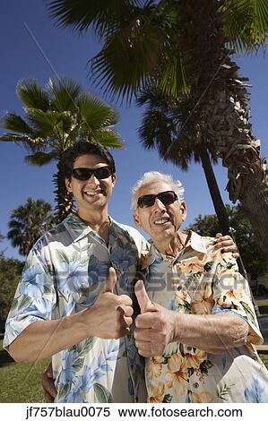 Father and adult son giving thumbs up outdoors View Large Photo Image Stock Photography - Father and adult son giving thumbs up outdoors. Fotosearch