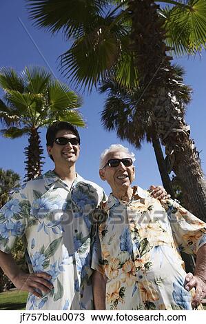 Father and adult son wearing sunglasses and Hawaiian shirts View Large Photo Image Stock Image - Father and adult son wearing sunglasses and Hawaiian shirts. Fotosearch