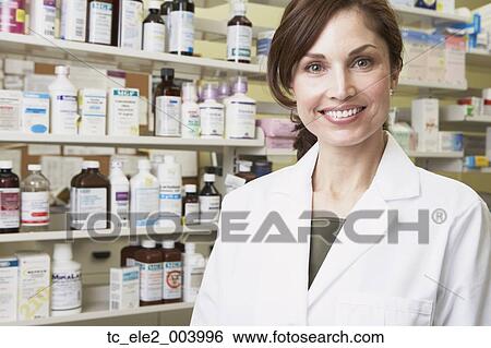 Female pharmacist smiling in pharmacy View Large Photo Image Stock Photograph - Female pharmacist smiling in pharmacy. Fotosearch